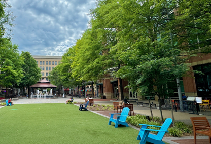 enclosed alcove with trees and blue chairs